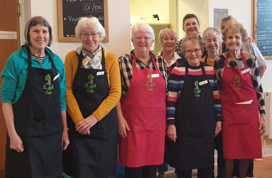 Volunteers and staff at the Mill, wearing new aprons and name badges