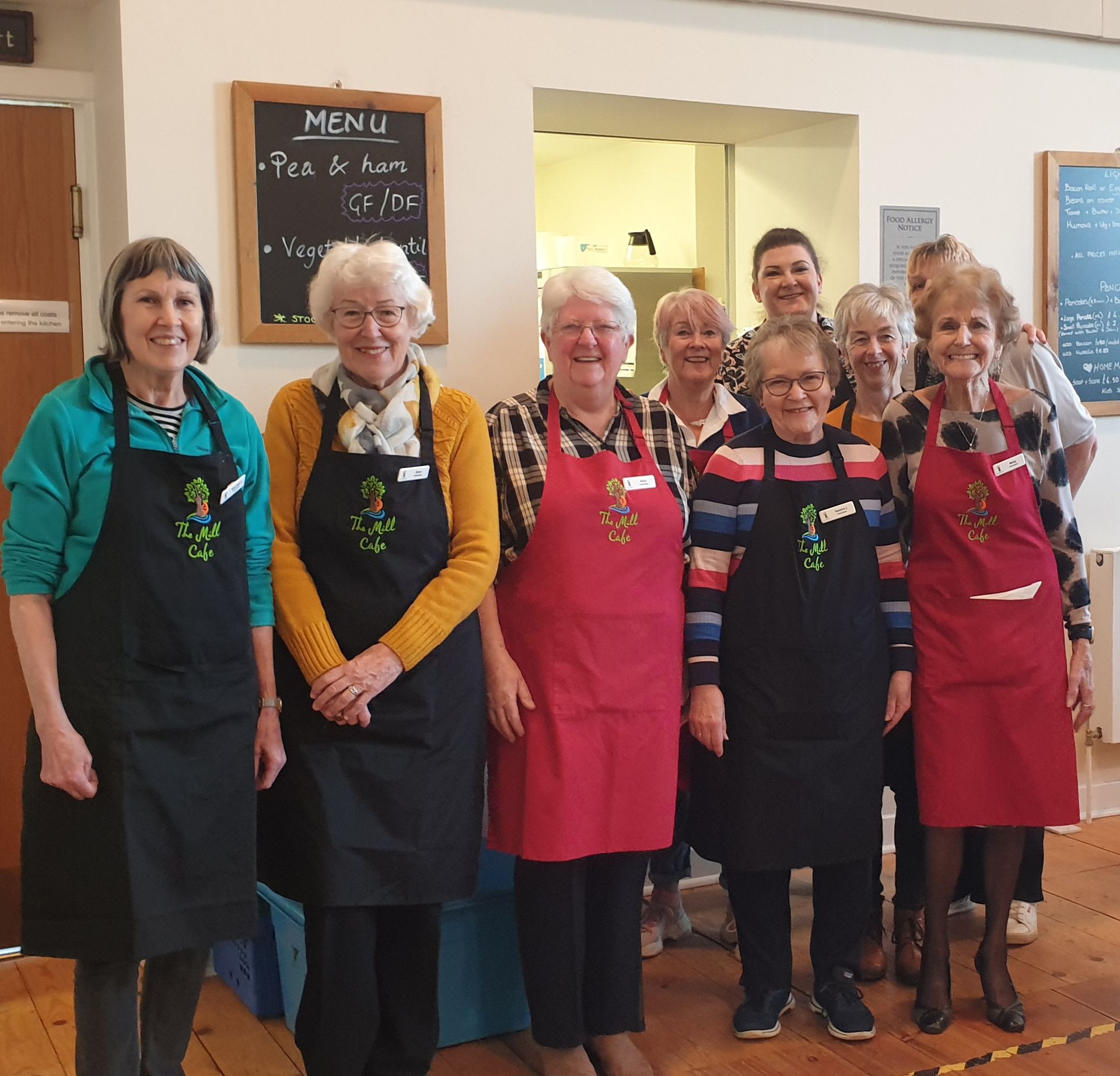 Volunteers and staff at the Mill, wearing new aprons and name badges