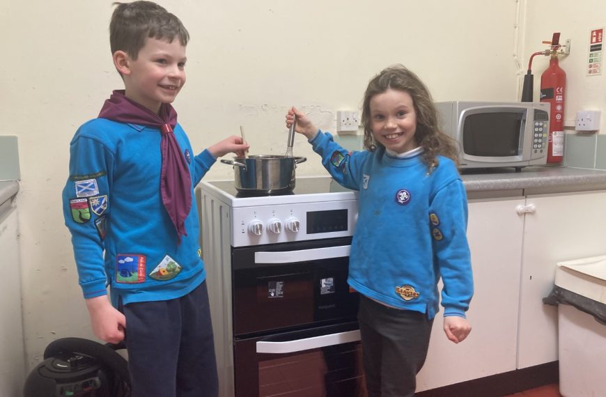Two Beaver Scouts standing next to the new cooker