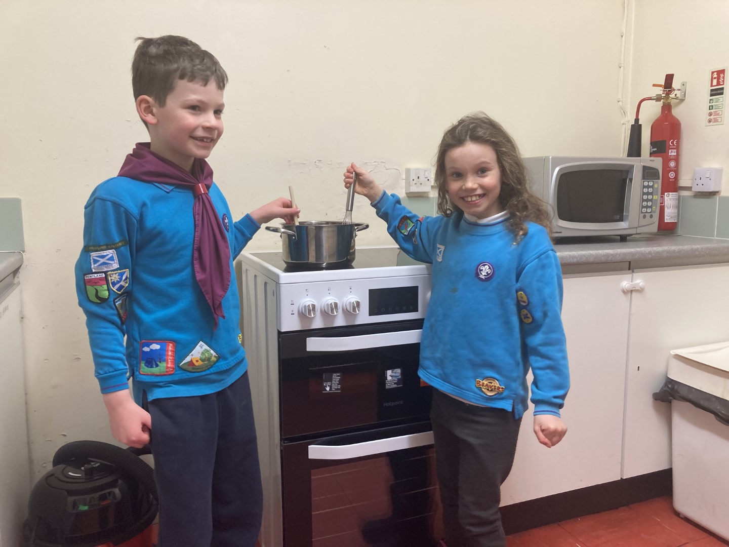 Two Beaver Scouts standing next to the new cooker