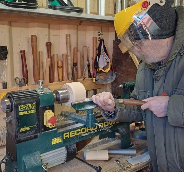 Pentlands Men's Shed member using lathe